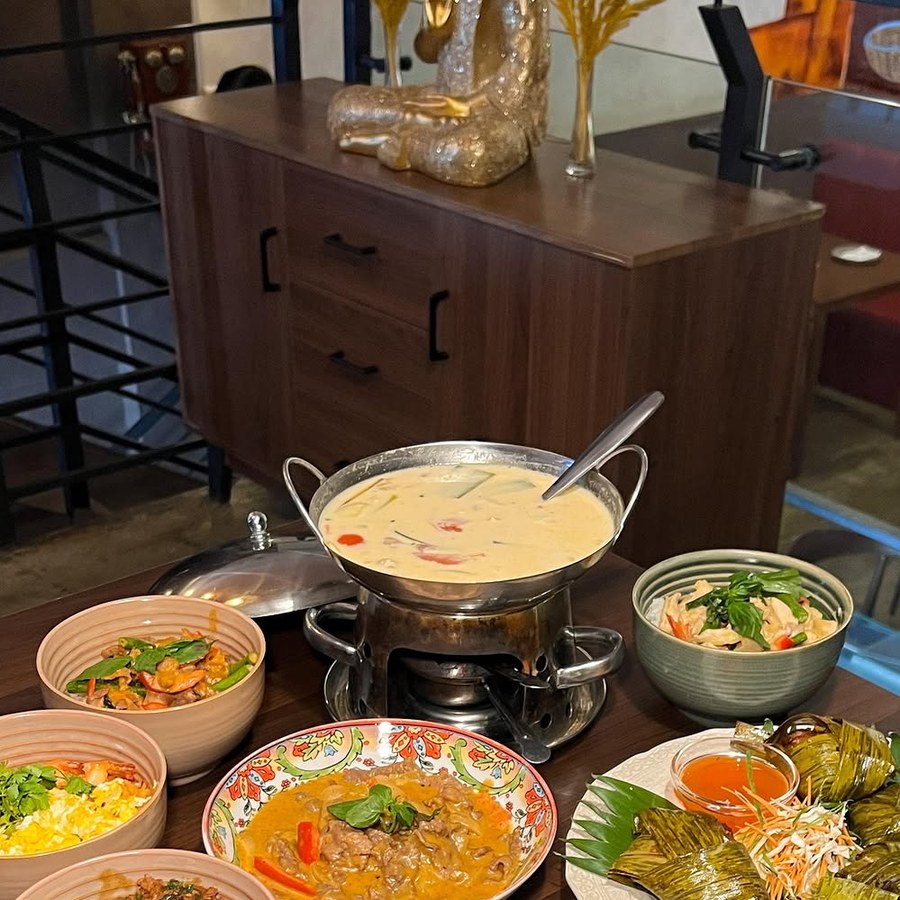 A spread of Thai curries and soups on the table