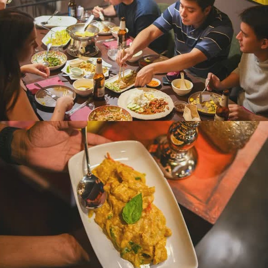 A full table sharing Thai dishes at Mad Thai